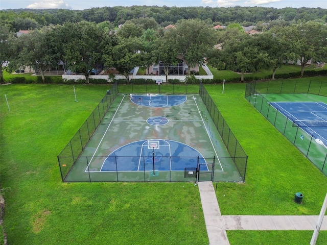 exterior space featuring a lawn and basketball court