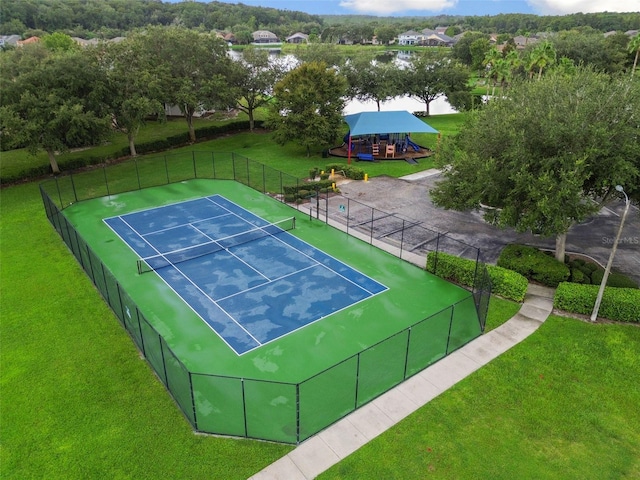 view of sport court featuring a playground and a yard