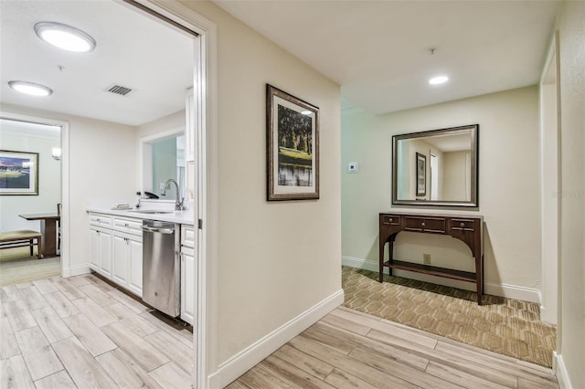 corridor with sink and light hardwood / wood-style floors