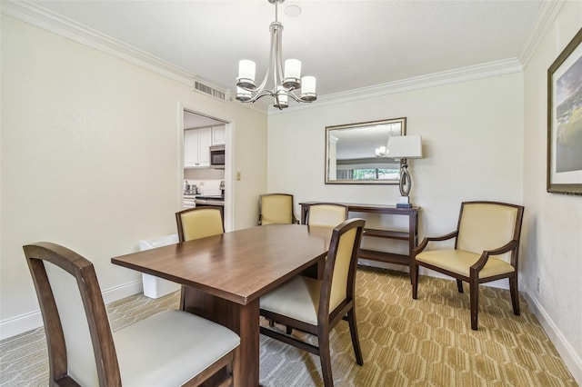 dining room with light colored carpet, a chandelier, and ornamental molding