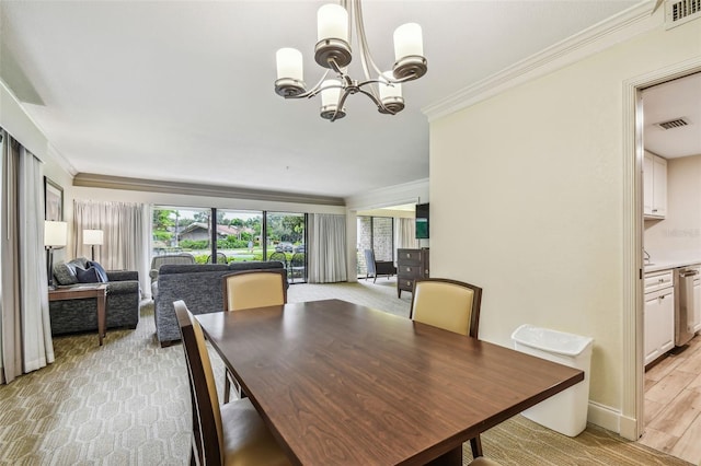 dining room featuring light hardwood / wood-style flooring, ornamental molding, and a chandelier