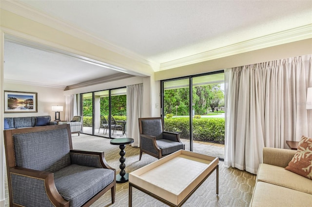 living room featuring ornamental molding, light carpet, and a textured ceiling