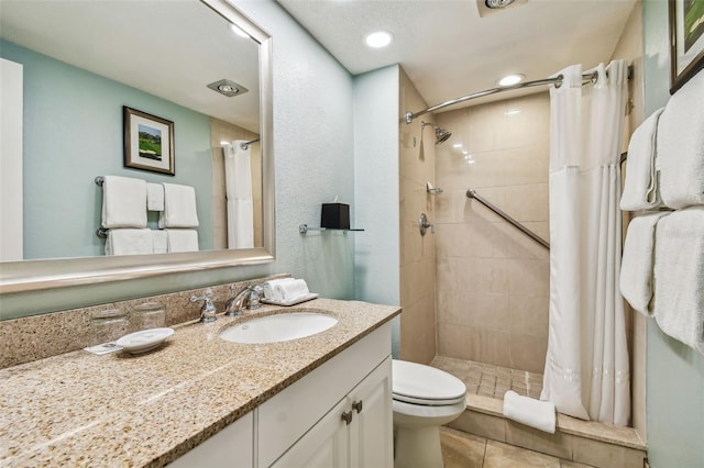 bathroom featuring a shower with shower curtain, toilet, vanity, and tile patterned floors