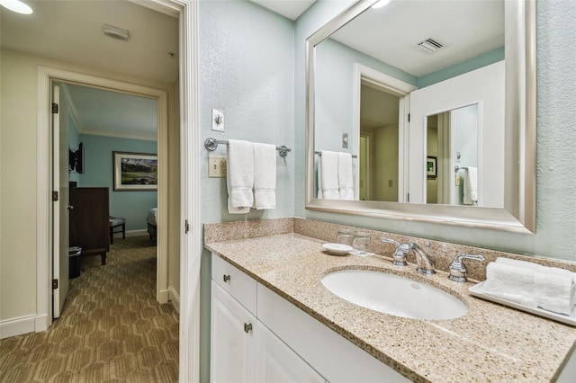 bathroom featuring vanity and ornamental molding