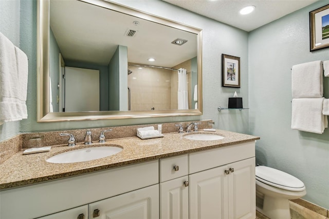 bathroom with vanity, toilet, and a shower with shower curtain