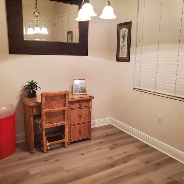 interior space with hardwood / wood-style floors and an inviting chandelier