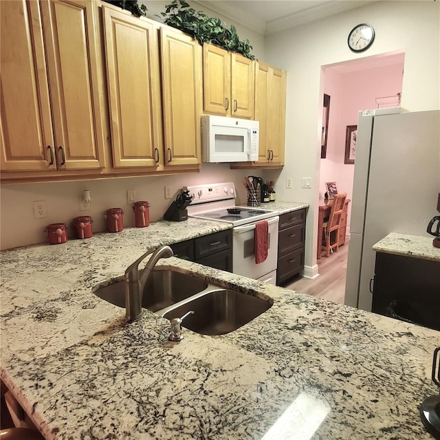 kitchen featuring light wood-type flooring, ornamental molding, white appliances, sink, and light stone countertops