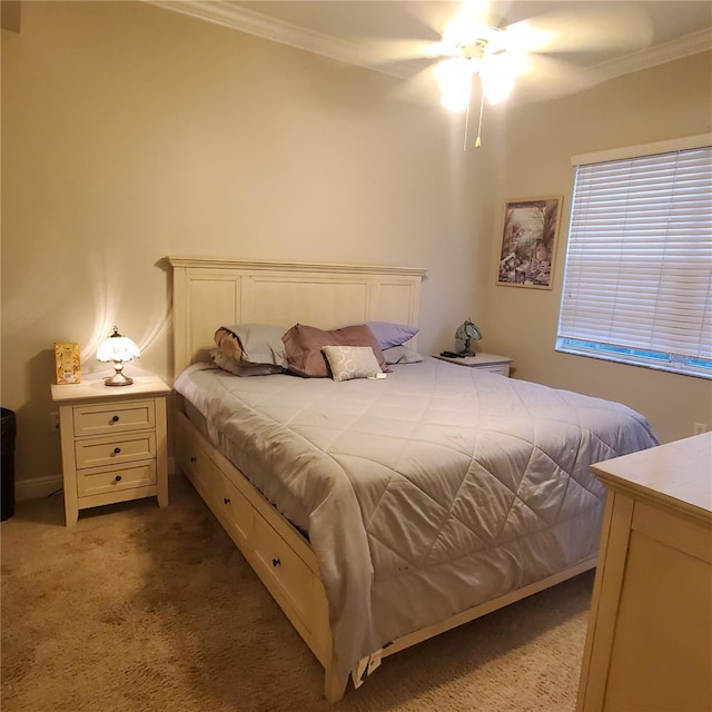 bedroom featuring crown molding, carpet flooring, and ceiling fan