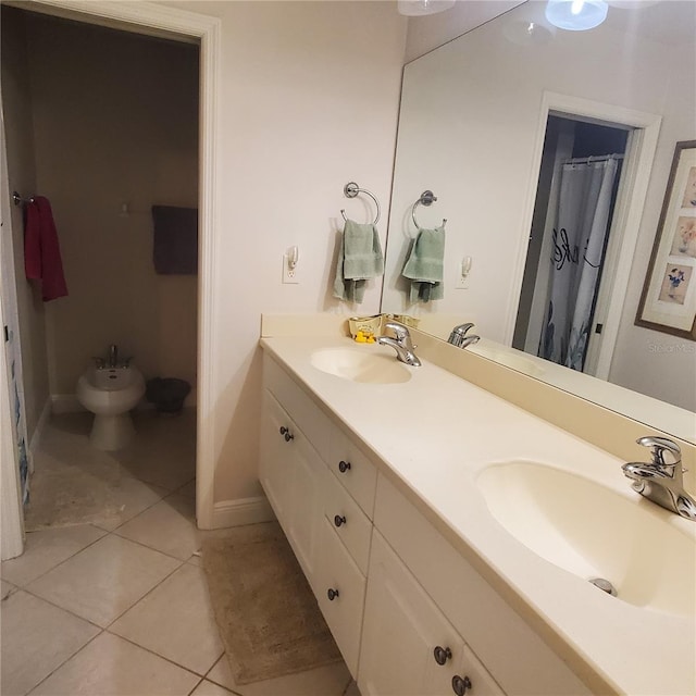 bathroom with tile patterned floors, a bidet, and vanity