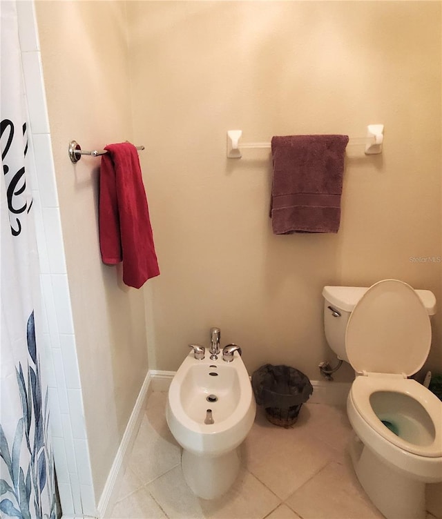 bathroom with a bidet, toilet, tile patterned floors, and walk in shower