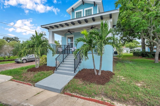 view of front of house with a porch, a front lawn, and ceiling fan