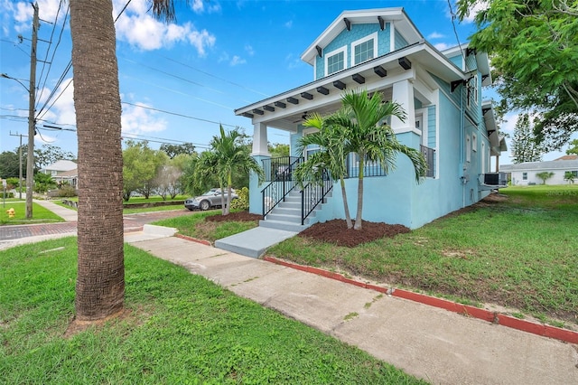 view of front of house with central AC, a front lawn, and a porch