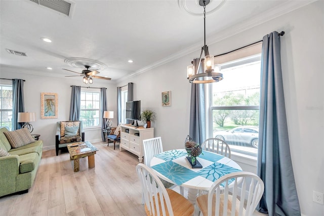 dining space featuring crown molding, ceiling fan, and light hardwood / wood-style flooring