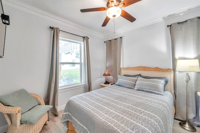 bedroom with light hardwood / wood-style flooring, ceiling fan, and ornamental molding