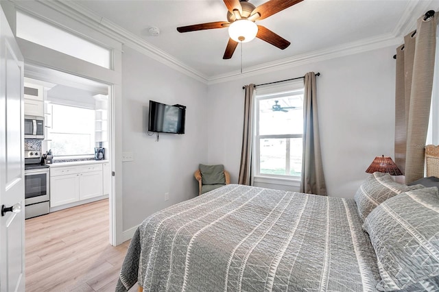 bedroom featuring crown molding, ceiling fan, and light hardwood / wood-style flooring