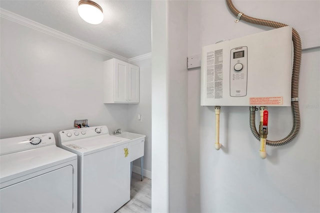 washroom with a textured ceiling, light hardwood / wood-style flooring, cabinets, separate washer and dryer, and water heater