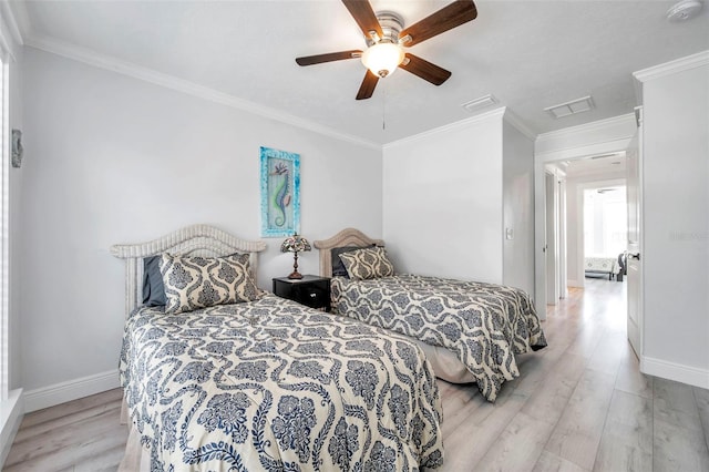 bedroom with crown molding, light hardwood / wood-style floors, and ceiling fan