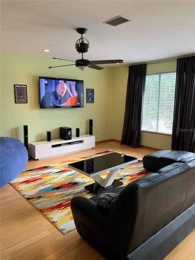 living room featuring hardwood / wood-style floors and ceiling fan