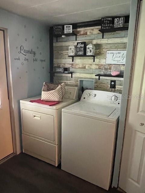 washroom with dark hardwood / wood-style flooring and independent washer and dryer