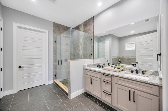 bathroom with tile patterned floors, vanity, and an enclosed shower