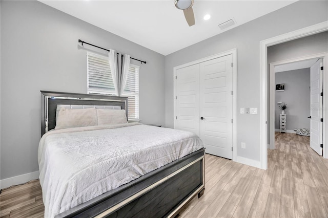 bedroom featuring ceiling fan, a closet, and light wood-type flooring