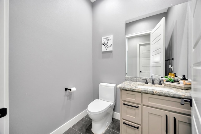 bathroom with tile patterned floors, vanity, and toilet