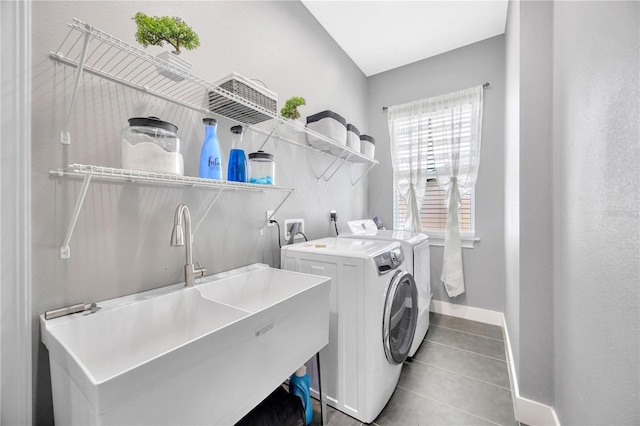 washroom featuring tile patterned flooring, separate washer and dryer, and sink