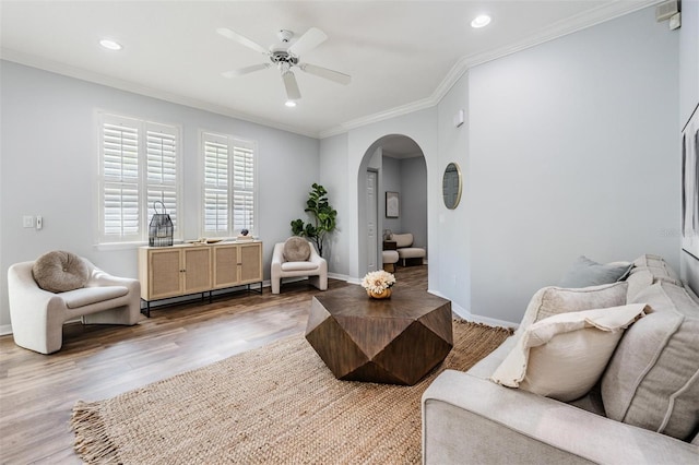 living room with ceiling fan, ornamental molding, and hardwood / wood-style floors