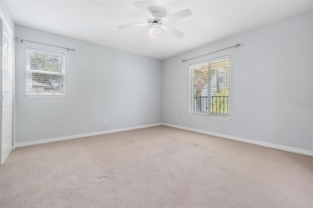 empty room with ceiling fan and carpet