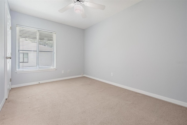 unfurnished room featuring ceiling fan and light carpet