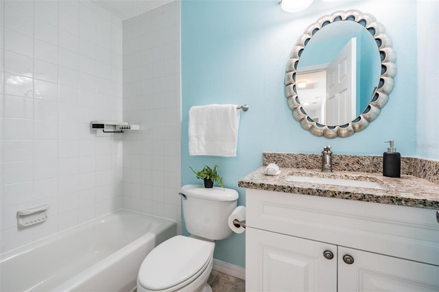 full bathroom featuring tile patterned flooring, toilet, tiled shower / bath combo, and vanity