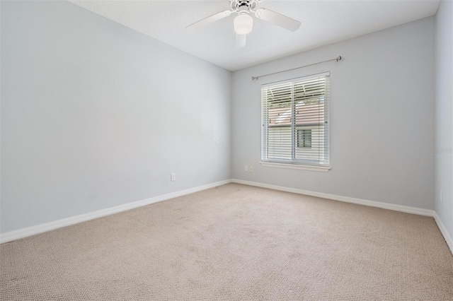 empty room featuring ceiling fan and carpet floors