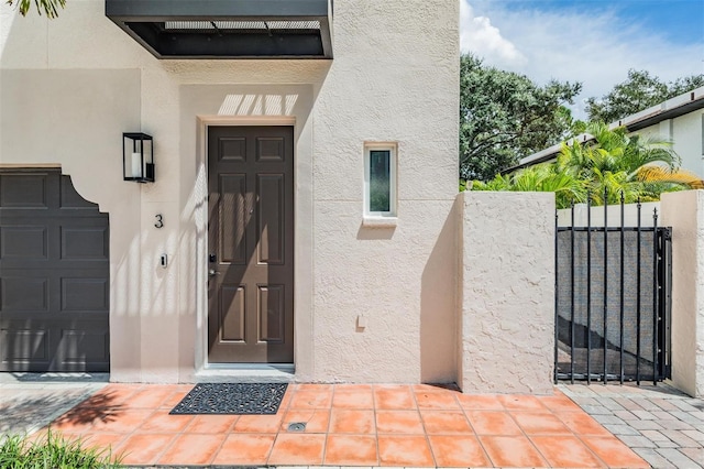 view of exterior entry with a garage