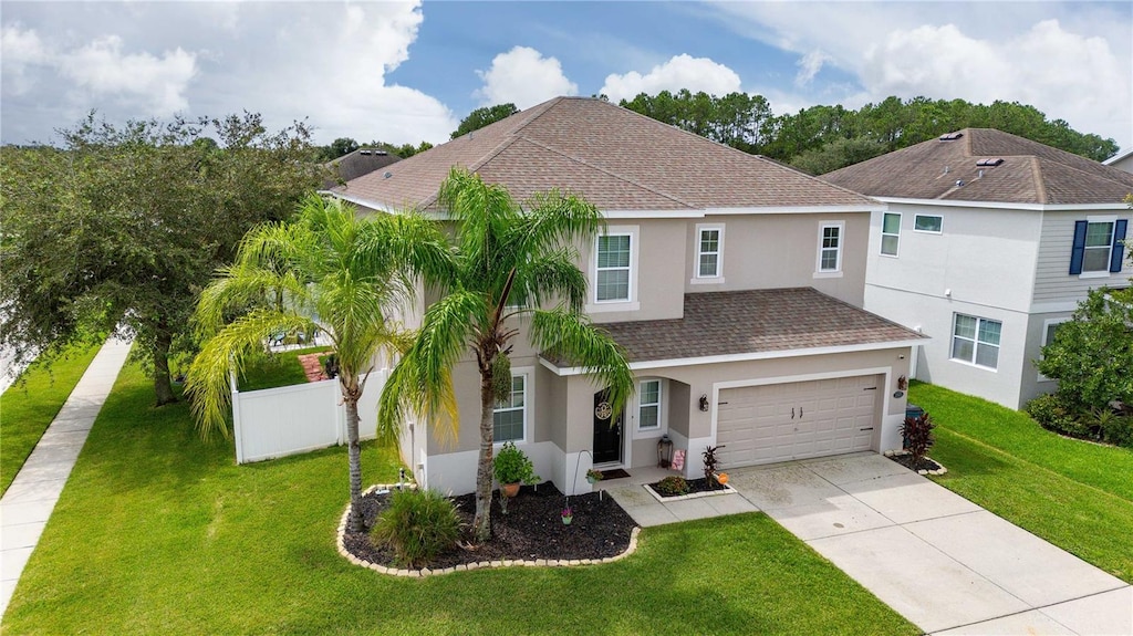 view of front of property with a garage and a front yard