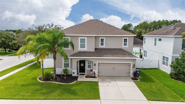 view of front of property with a front yard and a garage