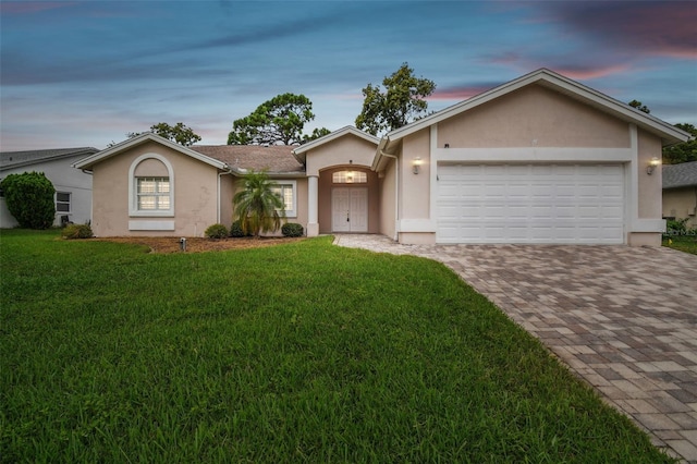 ranch-style house with a lawn and a garage