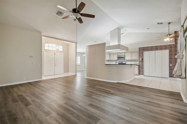 unfurnished living room with high vaulted ceiling, ceiling fan, wood-type flooring, and a textured ceiling