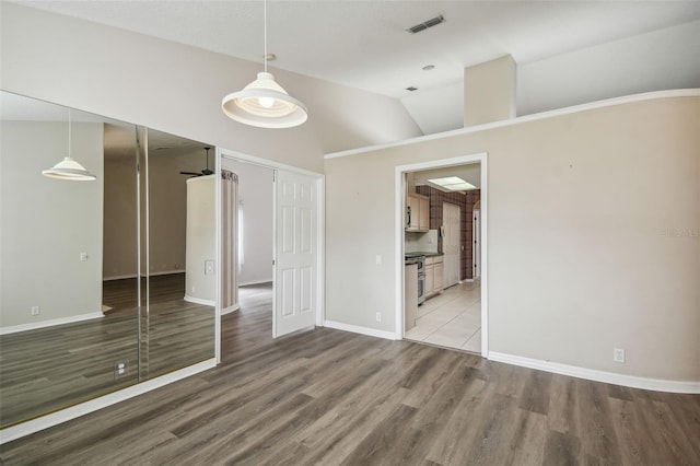 unfurnished bedroom with lofted ceiling and light hardwood / wood-style floors