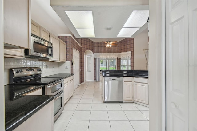 kitchen with ceiling fan, light tile patterned floors, and appliances with stainless steel finishes