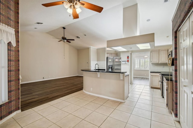 kitchen with light hardwood / wood-style floors, ceiling fan, cream cabinetry, and stainless steel refrigerator with ice dispenser