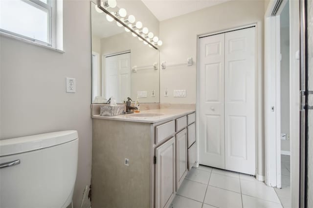 bathroom featuring vanity, toilet, and tile patterned floors