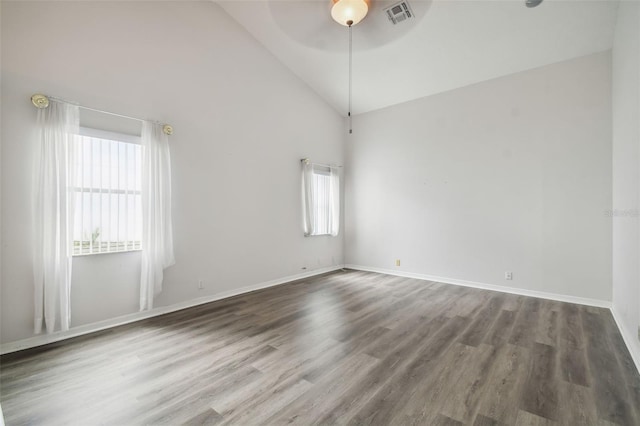 empty room with ceiling fan, hardwood / wood-style floors, and high vaulted ceiling