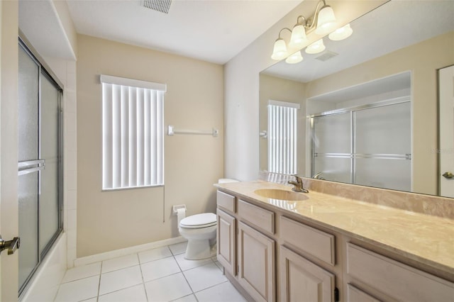 full bathroom featuring vanity, toilet, tile patterned floors, and enclosed tub / shower combo