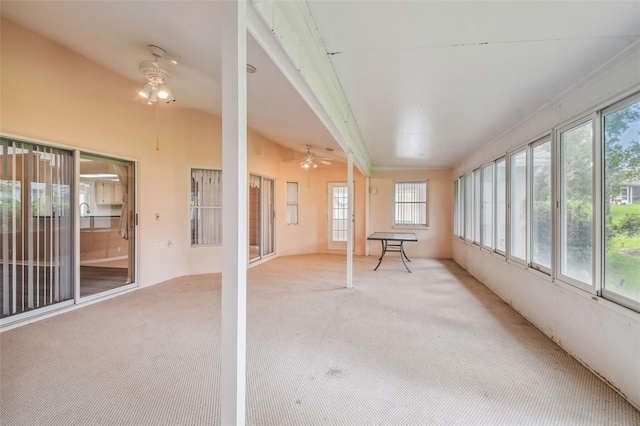 unfurnished sunroom featuring ceiling fan