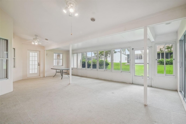 unfurnished sunroom with plenty of natural light and ceiling fan