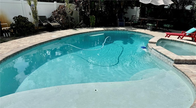 view of swimming pool featuring an in ground hot tub and a patio