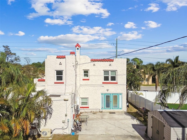 back of property featuring french doors, a patio, and ac unit