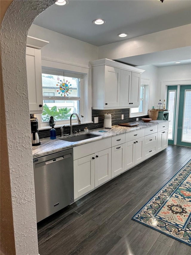 kitchen featuring dark hardwood / wood-style flooring, dishwasher, and white cabinets