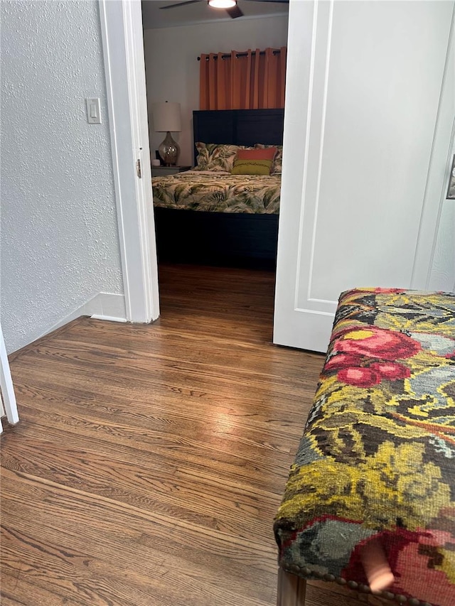 bedroom with dark wood-type flooring