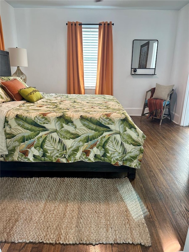 bedroom with dark wood-type flooring